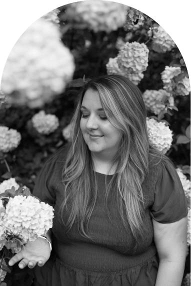 Elizabeth, looking at a hydrangea blossom